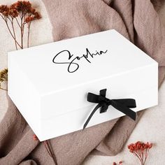 a white box with the word sophina on it and some flowers around it