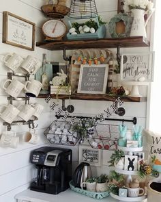 shelves filled with plates and cups on top of a kitchen counter next to a coffee maker