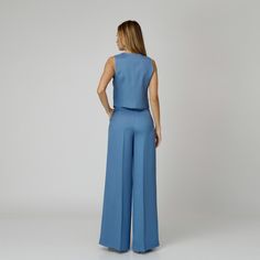 Introducing our Skye Silk Crepe Pants, a statement of luxurious comfort and timeless style. Tailored from  blue silk crepe with a wide-leg cut, they feature expertly placed darts that contour the waist and flatter the silhouette. The pressed crease detail offers a touch of refinement, elevating the overall look with understated polish. A concealed zipper and hook fastening in the front ensures a seamless finish, while the inclusion of pockets adds a practical yet chic element to the ensemble.  M Elegant Ankle-length Viscose Wide Leg Pants, Elegant Fitted Wide Leg Viscose Pants, Elegant Fitted Viscose Wide Leg Pants, Chic Blue Wide Leg Culottes, Formal Ankle-length Elegant Culottes, Elegant Wide Leg Viscose Pants, Formal Viscose Wide-leg Pants, Viscose Wide-leg Pants For Formal Occasions, Chic Formal Viscose Pants