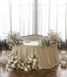 the table is set with flowers and candles