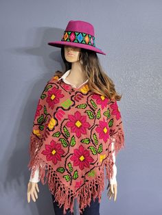 This gorgeous Mexican Artisanal Poncho is perfect for the cold months ahead! The multicolor Ethnic design adds that perfect pop of color and style to your wardrobe. This poncho is completely hand embroidered by cross stitch and handmade on a loom by Mexican Artisans in Puebla, Mexico. This poncho is knit, has open sides and it comes in one size so anyone ranging from size Small to Extra Large will be able to wear it. Hippie Shawl Poncho For Festivals, Bohemian Handwoven Shawl Poncho, Traditional One-size Fall Cape, Traditional One-size Cape For Fall, Traditional One Size Cape For Fall, Red Bohemian Poncho With Fringe, Red Bohemian Poncho For Festival, Traditional Red Poncho For Fall, Red Bohemian Poncho For Winter