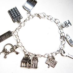 This charm bracelet features realtor inspired Tibetan silver charms. Each charm is attached to a silver tone bracelet that measures 7.5 inches in length. Silver Charm Bracelet, Tibet, Silver Charms, Charms, Silver Tone, Jewelry Bracelets, Bracelet, Charm Bracelet, Accessory Gift