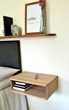 a bed with a wooden headboard and shelf above it