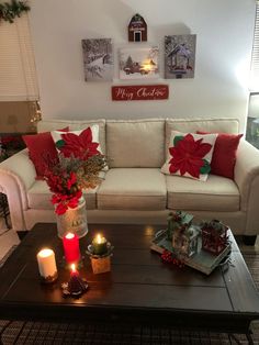 a living room filled with furniture and christmas decorations on top of a wooden coffee table