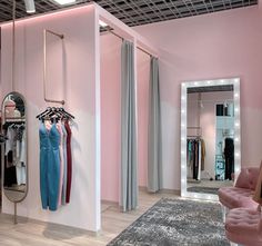 a clothing store with pink walls and mirrors