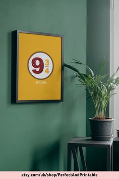 a green wall with a yellow and red sign hanging on it's side next to a potted plant