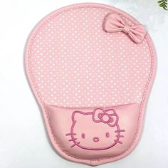 a pink hello kitty pot holder with a bow on it's head and polka dots