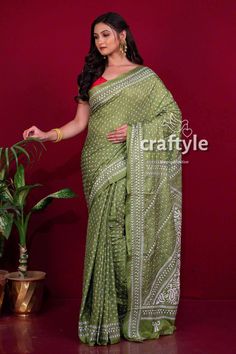 This is authentic hand embroidered Kantha Stitch Saree from Santiniketan, Birbhum district in Bengal. The unique multi-thread kantha embroidery design is entirely handcrafted by our skilled artisans. The most significant aspect of hand embroidery is the running stitch pattern that accentuates the various motifs. The running blouse piece is included with this soft silk saree. Saree Length : 5.5 meters Blouse Piece Length : 0.8 meters Design : Hand Kantha Work Fabric : Blended Bangalore Silk Color Traditional Cotton Embroidered Fabric With Zari Work, Chikankari Embroidery Mulmul Traditional Wear For Puja, Traditional Cotton Wear With Zari Work, Bohemian Cotton Blouse With Cutdana, Traditional Cotton Wear With Zari Work For Ceremonies, Traditional Cotton Fabric With Zari Embroidery, Traditional Mulmul Saree With Cutdana, Traditional Cotton Saree With Zari Work, Traditional Green Cotton Blouse Piece