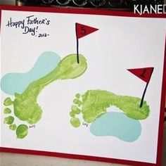 a handprinted card for father's day with green footprints and red flag