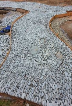 a cobblestone walkway is being built in the middle of an area that looks like it has been paved