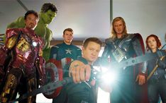 the avengers team is posing for a photo with their arms in the air and one man pointing