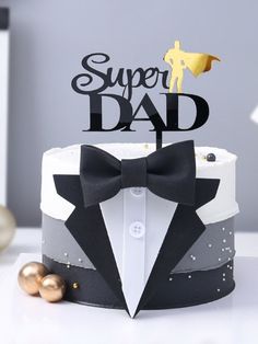 a birthday cake with a bow tie and the words super dad written on it in black