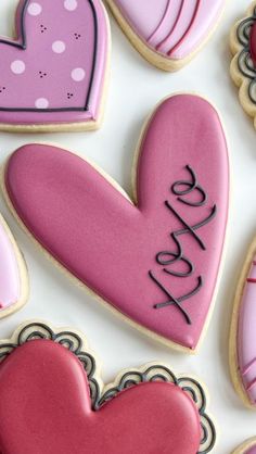 heart shaped cookies with the word love spelled on them