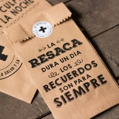 some brown paper bags sitting on top of a wooden table