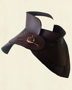 a brown leather hat with a brass buckle