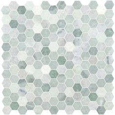 a white and green tile pattern with hexagonal shapes