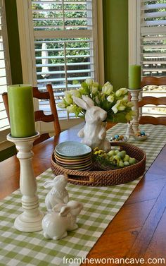 a dining room table set for easter with candles and bunny figurines on it