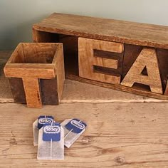 two pieces of wood sitting on top of a table next to each other with erasers in front of them