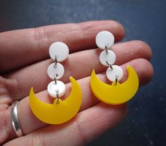 "Pretty Soldier Sailor Moon Cosplay Earrings are made of laser cut yellow acrylic and white acrylic. ★ Super lightweight and perfect for detailed cosplay, these dangle pendants are secured upon your choice of studs. Pick from: ~Nickel Free (Shown) ~Stainless Steel ~Plastic Studs ~Clip Ons ~Titanium Studs ★ Costume Jewelry pendants measure just under 1.5\" long and .75\" wide each. ★ Fighting evil by moonlight, wining love by daylight. Never running from a real fight! She is the one named Sailor Detailed Cosplay, She Is The One, Moon Cosplay, Sailor Princess, Sailor Moon Cosplay, Princess Cosplay, Usagi Tsukino, Jewelry Pendants, Moon Earrings