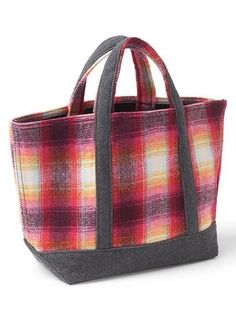 a red and yellow plaid tote bag on a white background with the handles down