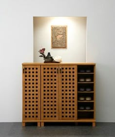 a wooden cabinet with baskets on it in a room