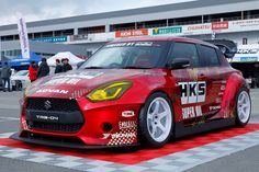 a red sports car parked on top of a race track