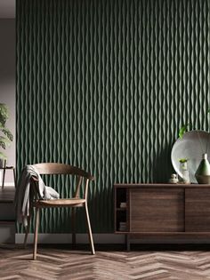 a room with green wallpaper and a wooden chair in front of a dresser next to a potted plant