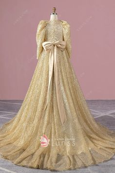 gold stiff glitter bubble sleeve formal gown with a bow Gold Long Sleeve Gown For Prom Season, Glamorous Gold Long Sleeve Gown, Glamorous Long Sleeve Gold Gown, Gold Long Sleeve Gown For Weddings, Gold Long Sleeve Sequined Gown, Gold Long Sleeve Gala Dresses, Gold Long Sleeve Dress For Gala, Gold Sequined Long Sleeve Gown, Luxury Long Sleeve Gold Gown