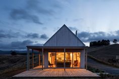 a small wooden house sitting on top of a grass covered field