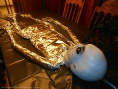 a tea pot covered in foil sitting on top of a table