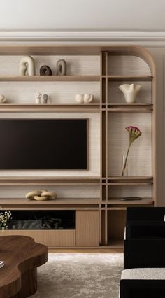 a living room with a couch, coffee table and entertainment center in the middle of it