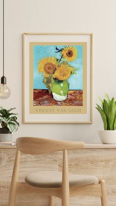 a vase filled with yellow sunflowers sitting on top of a wooden table next to a potted plant