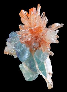 an orange and blue piece of crystal on a black background