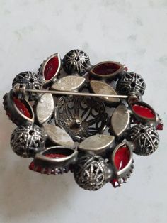 This is a vintage red, glass rhinestone and steel cut brooch. My best guess is that this is from the 1940s. I think it may be older however. It is really a stunning piece. The brooch measures about 2 inches across. Don't forget to stop in at my other Etsy shop... http://www.etsy.com/shop/xtdesigns. Follow me on Twitter at... MyYiayiaHadThat@MyYiayiaHadThat. If you have a wish list or are looking for something specific, please ask. I may have exactly what you are looking for. As always please con Vintage Red Pins For Party, Vintage Red Pins As Gift, Vintage Red Pins For Gift, Vintage Red Brooches For Formal Occasions, Vintage Red Brooches For Party, Vintage Red Pins For Gifts, Vintage Red Wedding Brooches, Antique Red Brooch Jewelry, Elegant Red Brooches Collectible