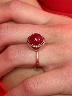 Breathtaking in its classic simplicity and timeless design, this vibrant eye catching ruby cabochon with a subtle sheen is accentuated with a pave of sparkling fancy cognac red diamonds. Alone or stacked with the rings from our collection,it is absolutely perfect. Ruby cabochon 11mm Diamonds size 1.1mm 9K solid rose gold Follow us on Instagram: https://www.instagram.com/missionewyork/ Ruby Ring Cabochon, Luxury Red Cabochon Ruby Ring, Luxury Ruby Ring With Cabochon Cut, Luxury Ruby Ring Oval Cabochon Polished Finish, Luxury Ruby Ring Oval Cabochon With Polished Finish, Luxury Ruby Ring With Oval Cabochon And Polished Finish, Luxury Cabochon Ruby Ring For Anniversary, Formal Cabochon Domed Ruby Ring, Elegant Domed Ruby Ring