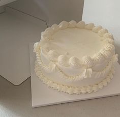 a large white cake sitting on top of a table