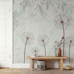 a wooden table sitting in front of a wall with dandelions painted on it