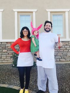 a man, woman and child dressed up in costumes