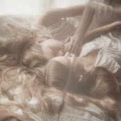 blurry photograph of two people sleeping on a bed