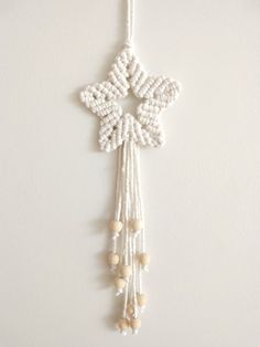 an ornament hanging on the wall with beads