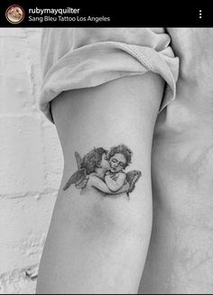 a woman with a tattoo on her thigh is holding a small bird and hugging it's face