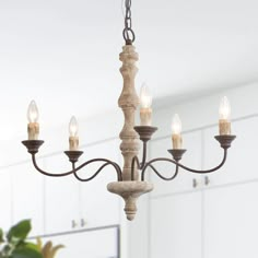 This luxury handmade wooden chandelier with the antique wood finish and rust metal design, gives you a thick sense of history and timeless French country charm. Inspired by traditional European chandelier silhouette, this 5-light French country distressed white wood and antique bronze chandelier features a mango wood and birch wood frame and a series of metal scroll arms, embracing an understated elegance. It is a perfect choice for your dining room, kitchen island, foyer, living room and bedroo Country Ceiling Lights, French Country Chandelier, Country Chandelier, Farmhouse Chandeliers, Chandelier For Dining Room, Wooden Chandelier, Rustic Pendant Lighting, Wood Candle, Bronze Chandelier