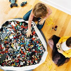 two children playing with legos on the floor