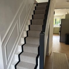 there is a set of stairs leading up to the second floor in this house with carpeted steps