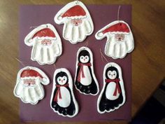 christmas ornaments made to look like penguins with hats and scarfs