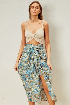 Indulge in your Moroccan dreams with our Sunrise Vacay Skirt! Featuring a stunning print and a flattering ruching effect, this satin skirt will be the center of attention on your next vacation. The full elastic waistband ensures a comfortable fit, while the unique design adds a touch of elegance to your wardrobe. PRE-ORDER 06/14/24 Fabric & fit: 100% rayon Model is wearing size small. Vacation Rayon Midi Skirt, Vacation Midi Rayon Skirt, Vacation Long Rayon Skirt, Blue Gathered Skirt Bottoms For Vacation, Rayon Midi Skirt For Vacation, Long Rayon Skirt For Vacation, Beach Tiered Skirt With Ruched Details, Beach Maxi Skirt With Floral Print, Beach Season Floral Print Maxi Skirt