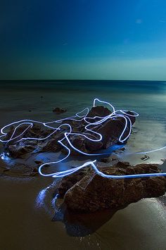 some rocks and water with lights on them