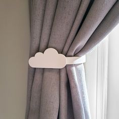 a curtain with a white cloud hanging on it's side