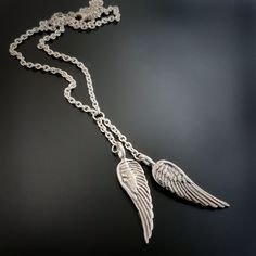 "Angel Wing Lariat Sterling Necklace Wild Prairie Silver Jewelry Handmade Angel Wings are handmade, solid sterling silver. The detail of the wings is on both sides of the wing so no matter which way they move the are perfect. This necklace comes on a medium weight chain 16-19\" adjustable. Leave a note in checkout if you would like a different length. I can make it in any length you prefer. Your choice of: 2 wings or a cross and wing - that is also shown in another listing and is oxidized. This Silver Winged Engraved Jewelry, Engraved Winged Sterling Silver Jewelry, Sterling Silver Wing-shaped Necklace, Silver Angel Wings Necklace, Silver Angel Wings, Angel Wing Necklace, Handmade Angels, Jewelry Website, The Wing