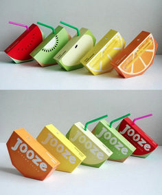 four different types of juice boxes with straws and orange slices on them, all lined up